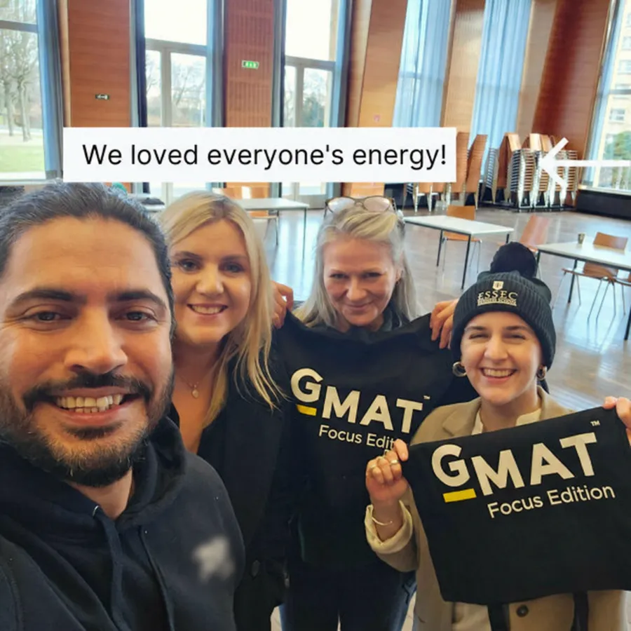 Iteros students holding GMAT Focus Edition banners